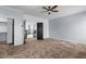 Spacious main bedroom featuring a ceiling fan, neutral carpet, and access to an ensuite bathroom and closet at 1233 E Azure Sea Ln, Gilbert, AZ 85234