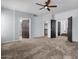 Large main bedroom with neutral carpet, ceiling fan, and ensuite bathroom access providing a tranquil retreat at 1233 E Azure Sea Ln, Gilbert, AZ 85234