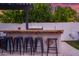 Charming outdoor bar area featuring a built-in fire feature and ample seating, perfect for entertaining guests at 1233 E Azure Sea Ln, Gilbert, AZ 85234