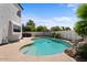 Resort-style pool with a rock waterfall feature and lush landscaping for privacy and relaxation in a serene backyard at 1233 E Azure Sea Ln, Gilbert, AZ 85234