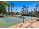 The tennis courts surrounded by lush landscaping, providing a scenic and private playing experience at 1233 E Azure Sea Ln, Gilbert, AZ 85234