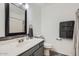 Bathroom with decorative vanity and framed mirror at 13444 W Ocotillo Ln, Surprise, AZ 85374