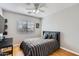 This bedroom features wood floors, ceiling fan and a large window at 13444 W Ocotillo Ln, Surprise, AZ 85374