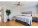 Inviting bedroom with hardwood floors, a ceiling fan, and a neutral color scheme at 13444 W Ocotillo Ln, Surprise, AZ 85374