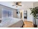 Spacious bedroom with hardwood floors, ceiling fan, and natural light, offering a serene atmosphere at 13444 W Ocotillo Ln, Surprise, AZ 85374