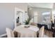 Dining room with light-colored walls and floors, adjacent to living room at 13444 W Ocotillo Ln, Surprise, AZ 85374