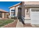 The front entrance with desert landscaping and a two car garage at 13444 W Ocotillo Ln, Surprise, AZ 85374