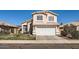 Exterior of a two-story house featuring a two car garage and desert landscaping at 13444 W Ocotillo Ln, Surprise, AZ 85374