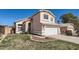 Two-story home featuring a two car garage and desert landscaping at 13444 W Ocotillo Ln, Surprise, AZ 85374