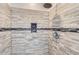 Beautifully tiled shower featuring a niche for storage and a modern shower head at 13444 W Ocotillo Ln, Surprise, AZ 85374