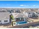 Resort-style backyard with pool, covered patio, desert landscaping, and mountain views at 1356 E Penedes Ct, Gilbert, AZ 85298