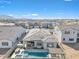 Stunning backyard featuring a modern pool, spa, covered patio, and desert landscaping at 1356 E Penedes Ct, Gilbert, AZ 85298