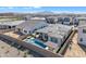 Amazing backyard features an in-ground pool, covered patio, desert landscaping, and mountain views at 1356 E Penedes Ct, Gilbert, AZ 85298