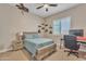 Comfortable bedroom featuring a wood frame bed and a modern ceiling fan at 1356 E Penedes Ct, Gilbert, AZ 85298