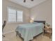 Cozy bedroom with a neutral color scheme, complemented by a modern ceiling fan at 1356 E Penedes Ct, Gilbert, AZ 85298