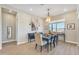 Elegant dining room with a stylish table setting, modern chandelier, and natural light from the window at 1356 E Penedes Ct, Gilbert, AZ 85298