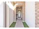 Inviting entryway featuring a brick-lined alcove leading to the front door with lovely plants and decor at 1356 E Penedes Ct, Gilbert, AZ 85298