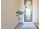 Close-up of the front door with wreath, stylish blue door, potted plant and welcome mat at 1356 E Penedes Ct, Gilbert, AZ 85298