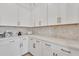 Kitchen area featuring white cabinets and countertops, stainless steel appliances and tile backsplash at 1356 E Penedes Ct, Gilbert, AZ 85298