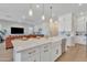 Modern kitchen island features seating, sink, and seamlessly connects to the adjacent living area at 1356 E Penedes Ct, Gilbert, AZ 85298