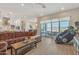 Open-concept living room with kitchen view, stylish sofa, and seamless access to the outdoor living space at 1356 E Penedes Ct, Gilbert, AZ 85298