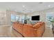 Spacious living room featuring a plush sectional sofa, tile floors, and a large sliding glass door to the patio at 1356 E Penedes Ct, Gilbert, AZ 85298