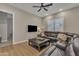 Comfortable living room featuring a leather sectional sofa and modern ceiling fan at 1356 E Penedes Ct, Gilbert, AZ 85298