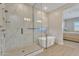 The main bathroom features a large walk-in shower and soaking tub with view to bedroom at 1356 E Penedes Ct, Gilbert, AZ 85298