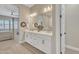 The main bathroom features a double sink vanity, large mirrors, stylish lighting and view to bedroom at 1356 E Penedes Ct, Gilbert, AZ 85298