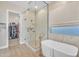 The main bathroom features a glass shower and soaking tub and view to walk-in closet at 1356 E Penedes Ct, Gilbert, AZ 85298