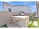 A backyard featuring an outdoor kitchen with stools and a grill, perfect for entertaining at 1356 E Penedes Ct, Gilbert, AZ 85298