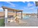 Outdoor kitchen with barstool seating and built-in grill is perfect for poolside gatherings at 1356 E Penedes Ct, Gilbert, AZ 85298