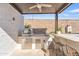 Outdoor kitchen features a built-in grill, barstool seating, and ample counter space at 1356 E Penedes Ct, Gilbert, AZ 85298