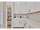 Pantry with built-in shelving for organized food storage, complemented by white cabinets and countertops at 1356 E Penedes Ct, Gilbert, AZ 85298