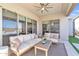 A large patio featuring outdoor furniture, ceiling fan, and sliding door access to the home's interior at 1356 E Penedes Ct, Gilbert, AZ 85298