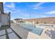 Beautiful pool area features a built-in spa, sunshade, and tranquil water feature at 1356 E Penedes Ct, Gilbert, AZ 85298