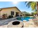 Beautiful backyard featuring a pool, fire pit, and patio area, designed for outdoor gatherings and enjoyment at 1412 E Jade Dr, Chandler, AZ 85286