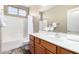 Bright bathroom with a shower-tub combo, white shower curtain, and a warm vanity at 1412 E Jade Dr, Chandler, AZ 85286