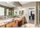 Bathroom featuring double sinks, tile floors, natural light, and a glass-walled shower at 1412 E Jade Dr, Chandler, AZ 85286