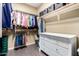 Walk-in closet with a variety of clothing neatly organized on hanging racks and a white dresser at 1412 E Jade Dr, Chandler, AZ 85286