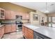 Bright kitchen with light-colored cabinets, stainless steel appliances, and adjacent dining area at 1412 E Jade Dr, Chandler, AZ 85286