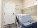 Laundry room features a washer and dryer, a storage shelf, and a door leading to the exterior at 1412 E Jade Dr, Chandler, AZ 85286