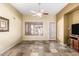 Neutral living room with tile floors, ceiling fan, and outdoor access at 1412 E Jade Dr, Chandler, AZ 85286