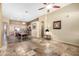 Open-concept living room with tile floors, ceiling fan, and access to kitchen and dining area at 1412 E Jade Dr, Chandler, AZ 85286