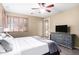 Bedroom featuring hardwood floors, a ceiling fan, a TV, and shutters at 1412 E Jade Dr, Chandler, AZ 85286