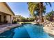 Stunning pool with rock features and lush landscaping creates a tranquil oasis in this backyard at 1412 E Jade Dr, Chandler, AZ 85286