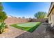 Private putting green in backyard provides a fun and convenient amenity for golf enthusiasts at 1412 E Jade Dr, Chandler, AZ 85286