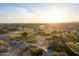 Expansive aerial view of lush golf course homes in a vibrant community at sunrise, creating a serene environment at 14257 W Harvard St, Goodyear, AZ 85395