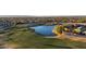 Panoramic view of a golf course with a lake, surrounded by houses, trees, and residential streets at 14257 W Harvard St, Goodyear, AZ 85395