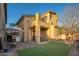 Outdoor view of the house with a patio area, grill, an outdoor table, and a small well maintained yard at 14257 W Harvard St, Goodyear, AZ 85395